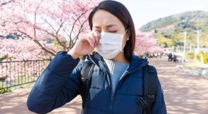 Woman suffer from allergy from pollen allergy at sakura season